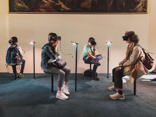 Ľudia využívajú headsety na virtuálnu realitu v múzeu.